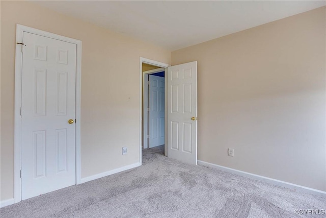 unfurnished bedroom featuring baseboards and carpet floors