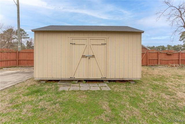 view of shed featuring fence