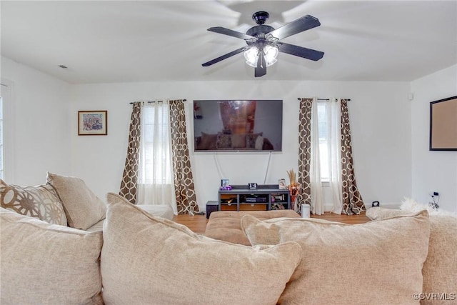 living room with a ceiling fan and a wealth of natural light