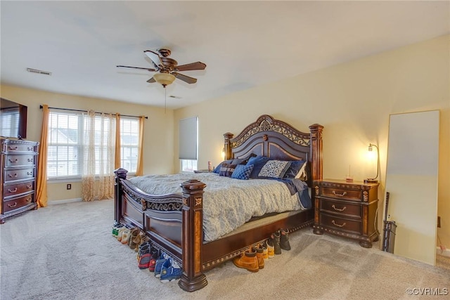 carpeted bedroom with visible vents and ceiling fan