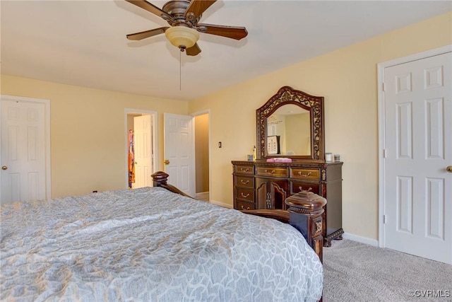 carpeted bedroom featuring baseboards and ceiling fan