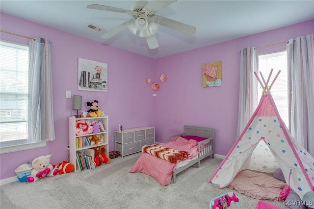 bedroom with multiple windows, visible vents, and carpet floors