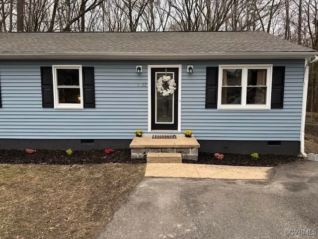 view of front of house with crawl space and roof with shingles