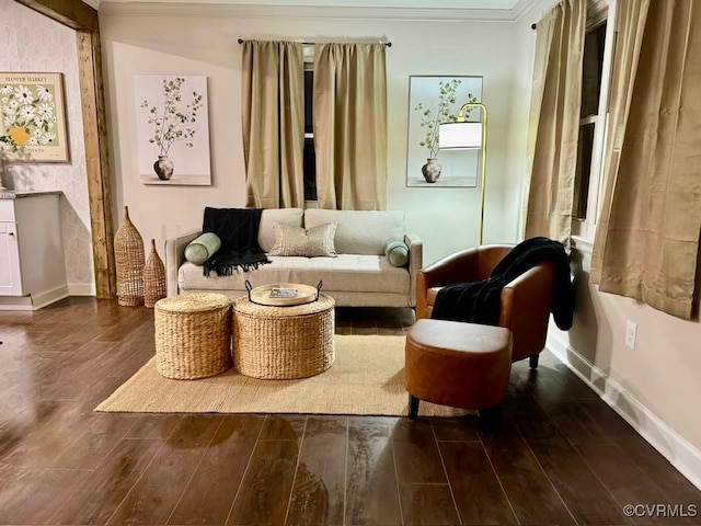 sitting room with crown molding, wood finished floors, and baseboards