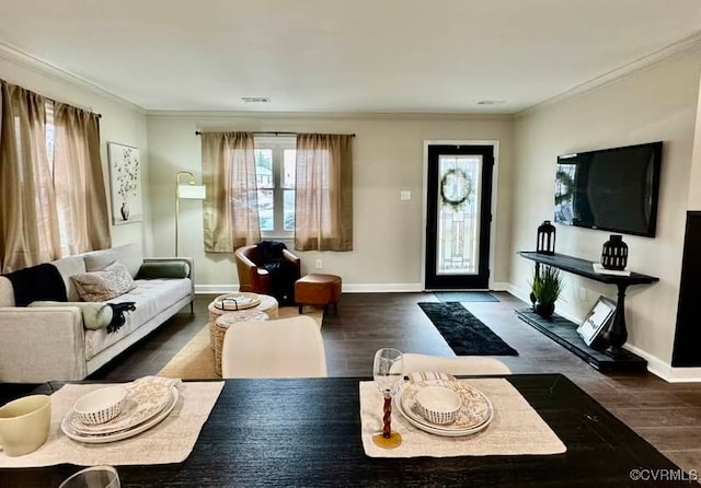 living area featuring visible vents, baseboards, wood finished floors, and ornamental molding