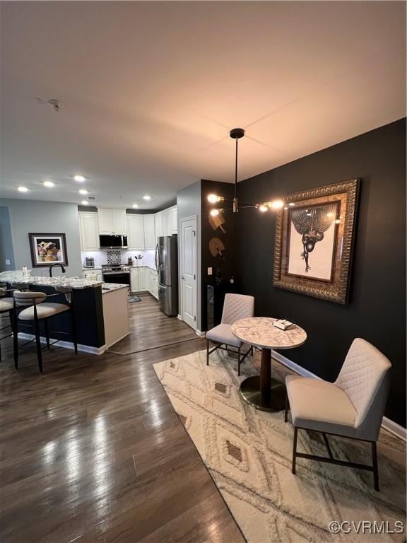 dining area with recessed lighting and dark wood-type flooring