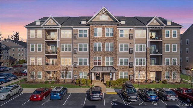 property at dusk with a residential view and uncovered parking