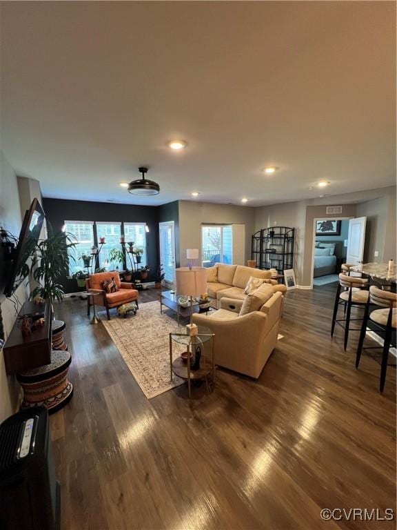 living area with dark wood finished floors and recessed lighting