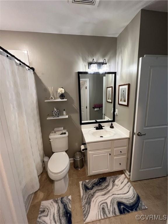 bathroom featuring baseboards, toilet, a shower with shower curtain, tile patterned floors, and vanity