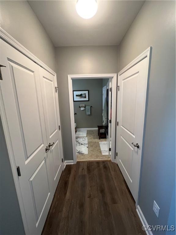 hall with dark wood-style flooring