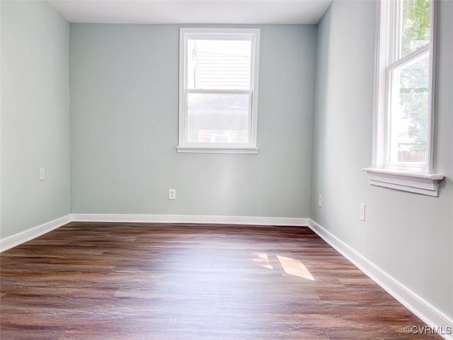 spare room with wood finished floors and baseboards