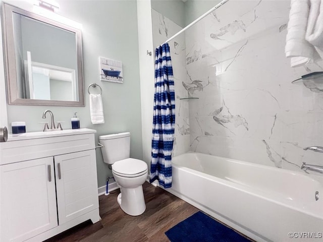 full bathroom with vanity, wood finished floors, baseboards, shower / bath combo, and toilet