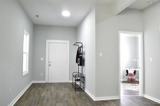 entryway featuring dark wood-type flooring and baseboards