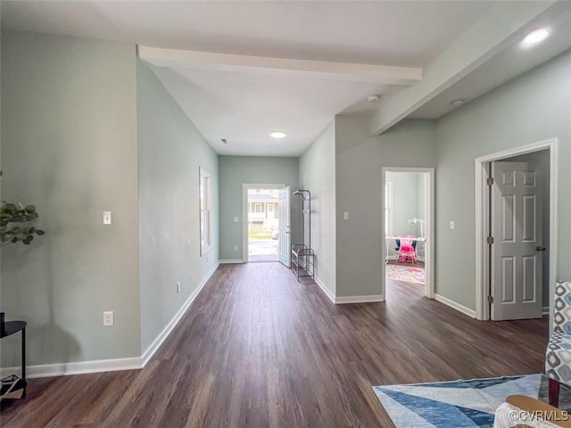 interior space with beamed ceiling, dark wood-style floors, and baseboards