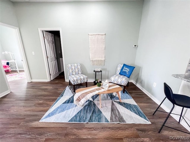 living area with wood finished floors and baseboards