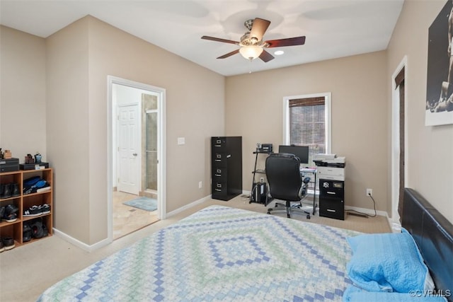bedroom with carpet floors, connected bathroom, baseboards, and ceiling fan