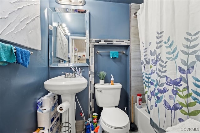 bathroom with toilet and shower / tub combo