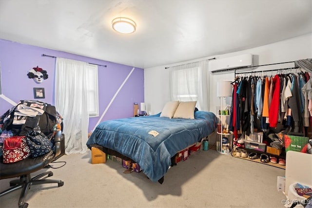 bedroom featuring a wall unit AC and carpet flooring