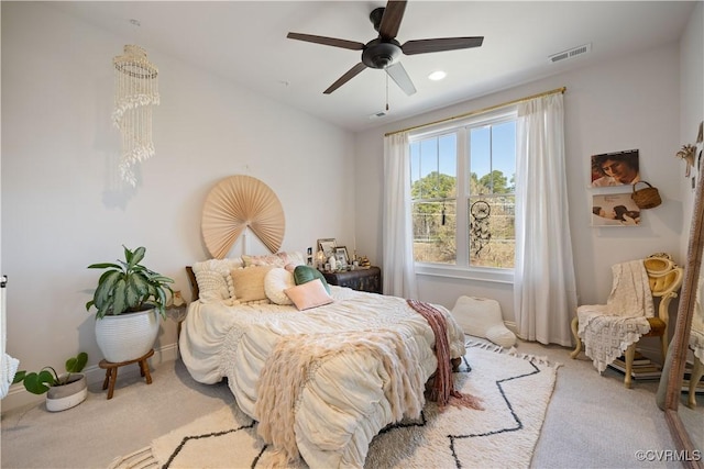 bedroom with light carpet, visible vents, baseboards, and a ceiling fan