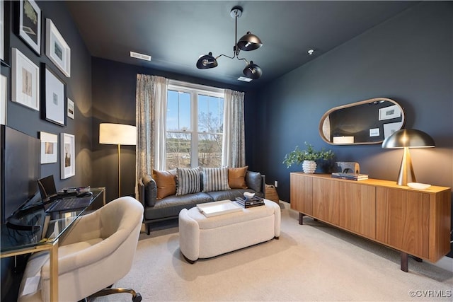 home office with a notable chandelier, light colored carpet, and visible vents