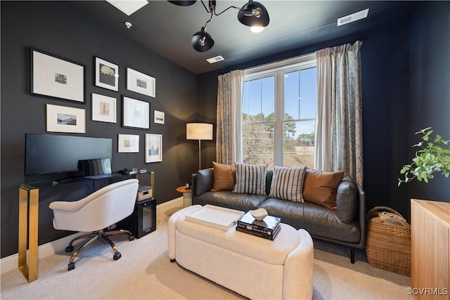 carpeted office with visible vents and baseboards