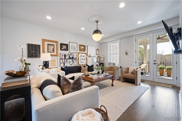 living room with recessed lighting, dark wood-style floors, and french doors