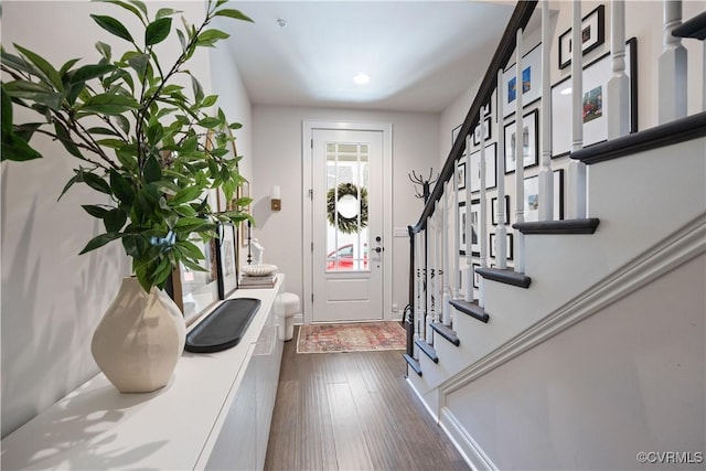 foyer with dark wood finished floors and stairs