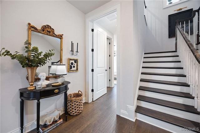 stairway featuring baseboards and wood finished floors