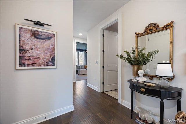 hallway with recessed lighting, wood finished floors, and baseboards