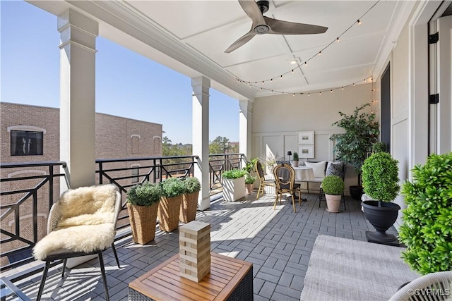 view of patio featuring a balcony, an outdoor hangout area, and a ceiling fan