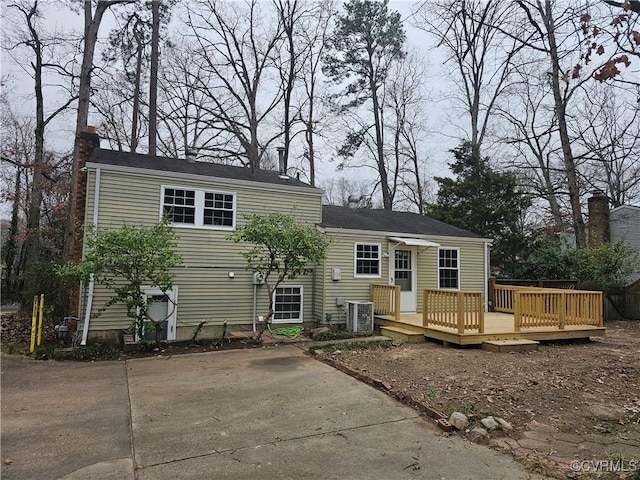 back of property featuring central AC and a deck