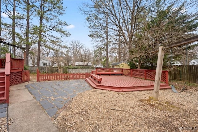 view of yard with a patio, a deck, and fence