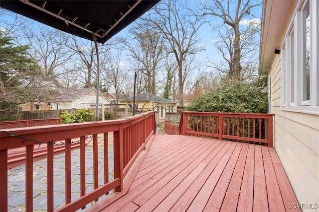 wooden terrace featuring fence