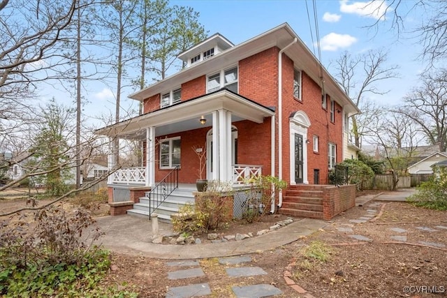 traditional style home with brick siding and a porch