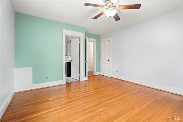 unfurnished bedroom with a ceiling fan, baseboards, ensuite bath, light wood-style floors, and a closet