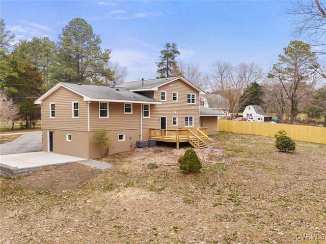 back of house with central AC unit, a wooden deck, a patio, and fence