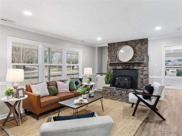 living room with visible vents, ornamental molding, and wood finished floors