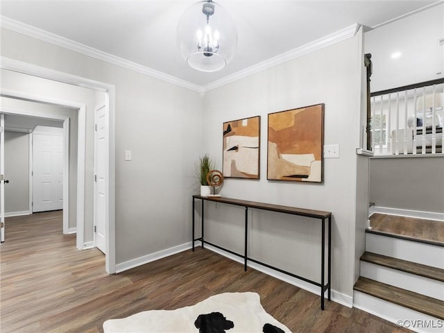 interior space featuring baseboards, stairs, ornamental molding, wood finished floors, and a notable chandelier