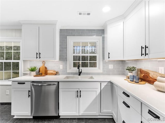 kitchen featuring visible vents, crown molding, stainless steel dishwasher, white cabinetry, and a sink