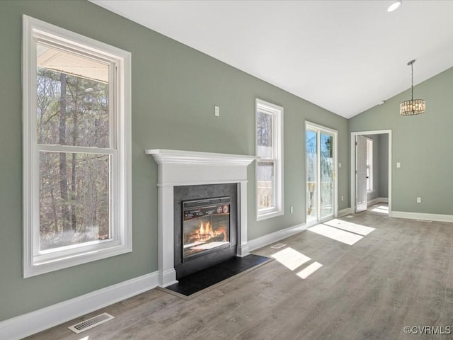 0 Silver Trail Cir, Lawrenceville, VA 23868 - unfurnished living room with plenty of natural light, a fireplace with flush hearth, baseboards, lofted ceiling, and wood finished floors