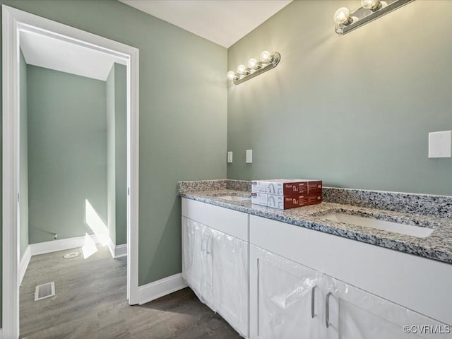 0 Silver Trail Cir, Lawrenceville, VA 23868 - bathroom featuring wood finished floors, double vanity, and baseboards
