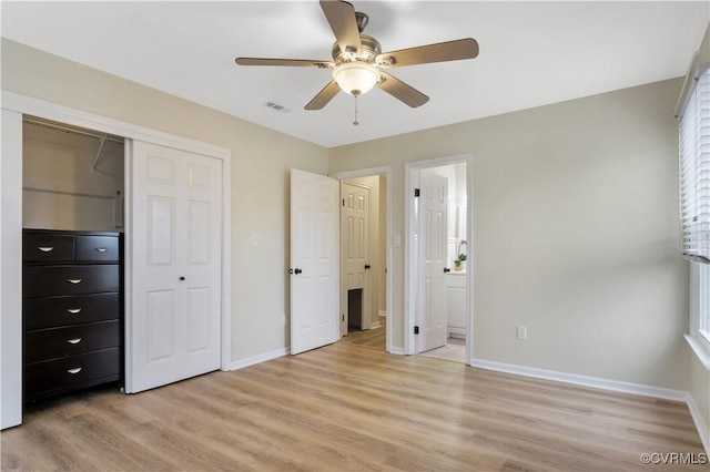 unfurnished bedroom with visible vents, baseboards, a closet, ensuite bathroom, and light wood-type flooring