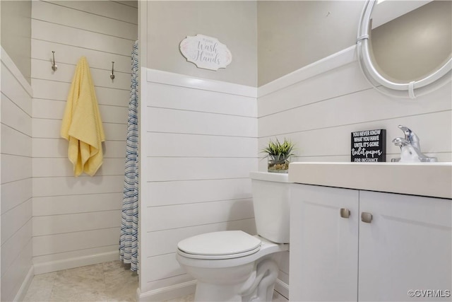 bathroom featuring tile patterned floors, a shower with shower curtain, toilet, and vanity