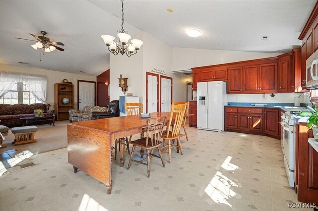 dining area featuring ceiling fan with notable chandelier, light floors, and high vaulted ceiling