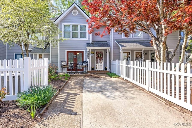 view of front of home featuring roof with shingles and a fenced front yard