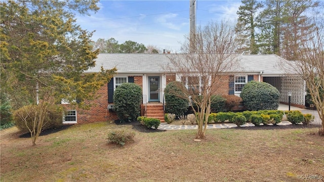 single story home featuring brick siding and a front yard