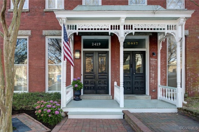 doorway to property with brick siding and french doors
