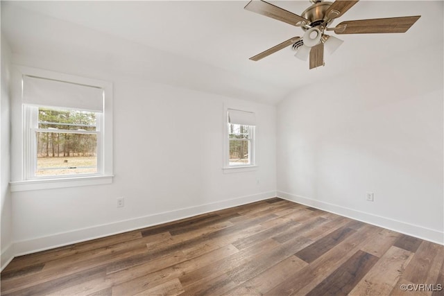 unfurnished room with ceiling fan, lofted ceiling, baseboards, and wood finished floors