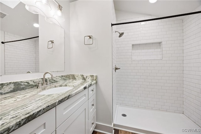 full bathroom featuring a stall shower and vanity