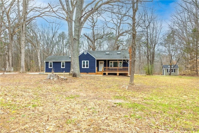 view of front of property with an outbuilding and a front lawn